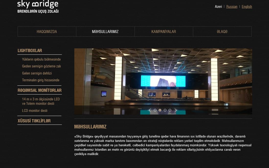Sky Bridge saytının məhsullar bölməsi: hər bir yerin fotoşəkli ilə laytbokslar, rəqəmsal monitorlar və xüsusi təkliflər.